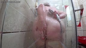 Appetizing Russian MILF washes in the shower and her fat body with huge