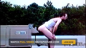 Crossdresser Riding a Giant Dildo on a Roof Top