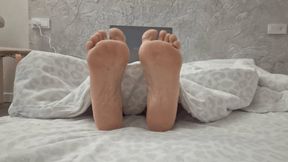 Soles from under the blanket