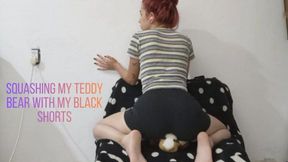 Squashing my teddy bear with my black shorts