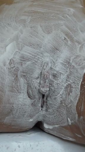 Close-up of shaving the vagina with a trimmer and a razor.   Clip 1