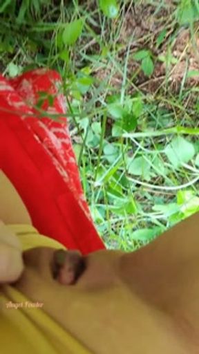 Slim Girl pissing standing like a man near the palm tree in the garden