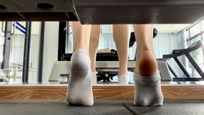 Dirty Gym Socks To Bare Feet. One By One Dirty Sweaty Socks Removal During Workout