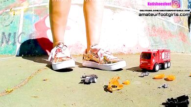 Kati grinds down cars with her sneakers and destroys toy trams