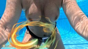 Carissa wearing the oval mask and weight belt while nude