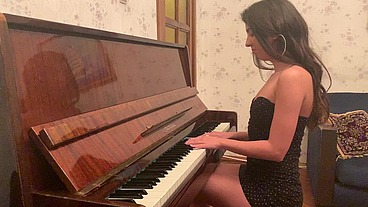 Young Katty West masturbating sitting on a piano