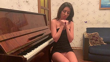 Young Katty West masturbating sitting on a piano