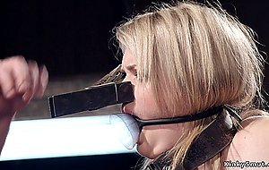 Gagged busty babe in bondage in dungeon