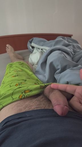 Cute handjob on the bed with a hard and erect penis