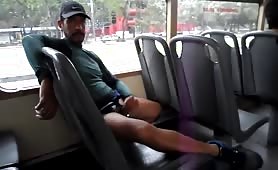 Horny guy stroking his cock in a public bus