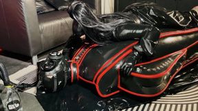 Rubberdoll teased in full rubber encasement sarcophagus with gas mask