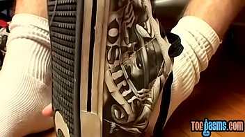 Thug jock Evan Heinze caressing socks in foot fetish solo