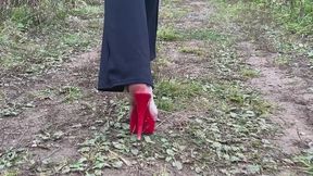 girl in extremely high shoes She walks in the mud, her shoes get stuck in the mud, and her toes get dirty
