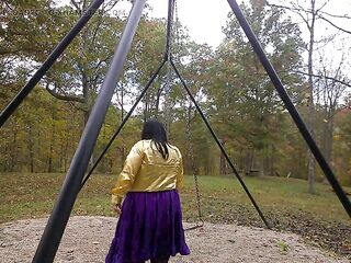 Hot Crossdresser at the park getting willing to begin swinging on the swing in the park.