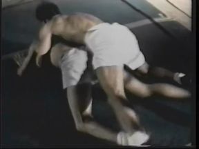 Guys with great bodies are having a wrestling game at the gym