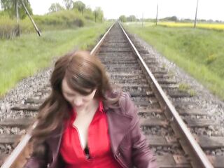 Naked in public. Woman without panties poses near train. Void urine public. Outdoor