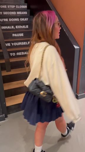 Woman in socks and sneakers plays with her upskirt