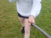 Crossdresser walks in the rain in tiny skirt