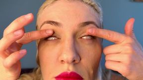 A blue-eyed blonde plays with her eyes