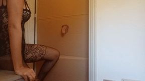 In a nylon catsuit and high heels I suck a cock and fuck it in a gloryhole until it cums in my mouth