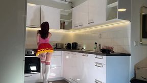 Sexy redheaded cheerleader in knee-high socks teases in kitchen