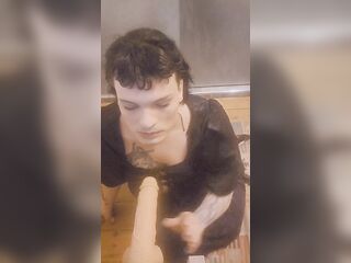 Trans woman on floor sucks sextoy