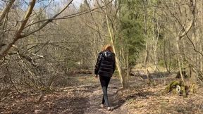 A girl walks barefoot through a spring forest, where mud is ankle-deep
