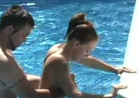 Nice bikini brunette gets poked doggy in the swimming pool
