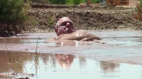 Deep, Creamy Brown Mud Bath in a Sand Pit