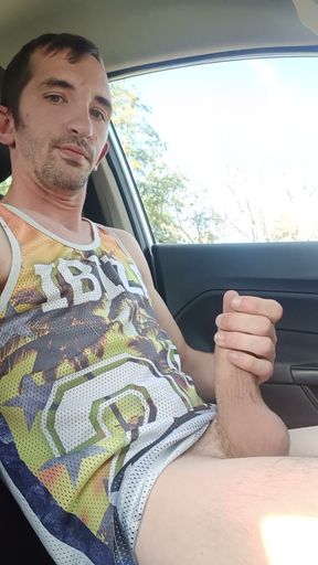A young man cums his big in his car