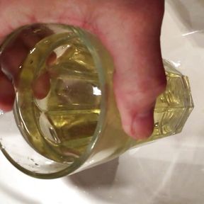 Golden pee in a drinking glass