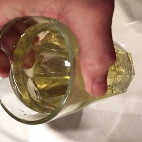 Golden pee in a drinking glass