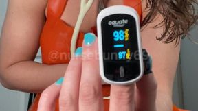 Pulse Oximeter and White Stethoscope Stimulation Testing with Vibrator in Orange Latex Apron 1080p