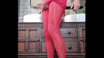 Tranny in dressed in Red pantyhose cums over nylon feet