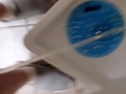 Sean pissing in amusement park mens room