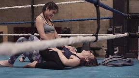 Two boxing babes are strapon fuck each others pussies in the ring