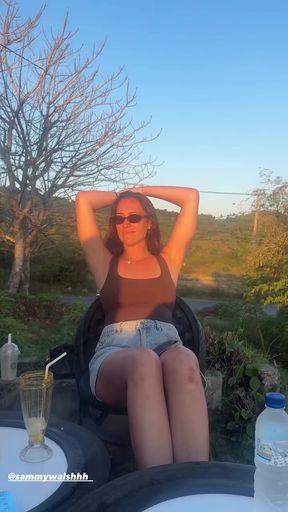Slim Aussie babe sits alone, playing with her armpits. She touches