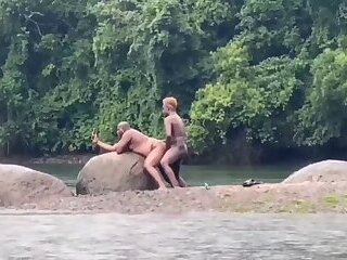 Fucking in the river in the rain with a hot bear and another hottie