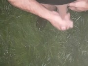 Uncut cock ejaculating a huge load onto the lush green grass in boots and t-shirt