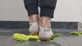 Guy crushing zucchini in ankle white socks