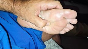 Giving her a soft foot rub and massage on the couch