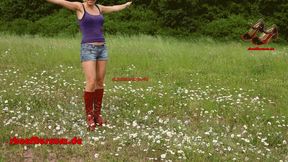 Three girls in boots walk over flowers 'Ramble1(3045)