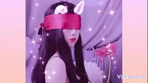 Asian girl bound by a scarf in BDSM scene