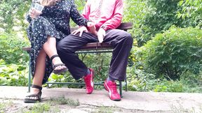 Hot MILF jerks off a big dick into a glass in the park on a bench