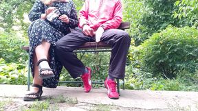 Hot MILF jerks off a big dick into a glass in the park on a bench