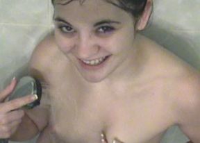 Cute coed Naomi plays in the shower