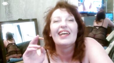Big redhead smokes alone in polka dot panties with natural tits