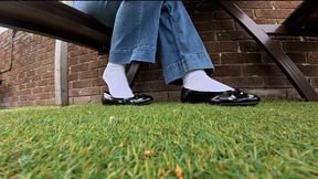 Under table outdoor shoeplay in ballet flats and white socks