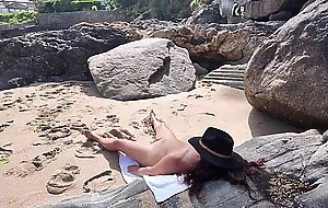 Suddenly a stranger sneaks up and starts touching milf`s hairy pussy on the beach