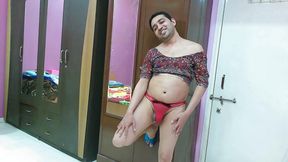Sexy sissy crossdresser femboy Sweet Lollipop in a printed top, red thong and satin slippers.